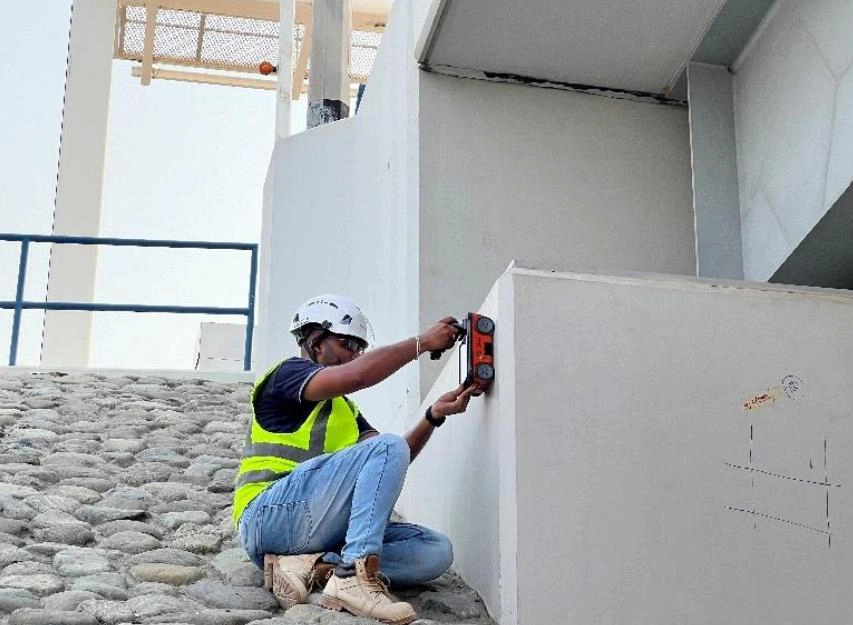 New Nordic engineer scanning a concrete wall beneath a bridge structure