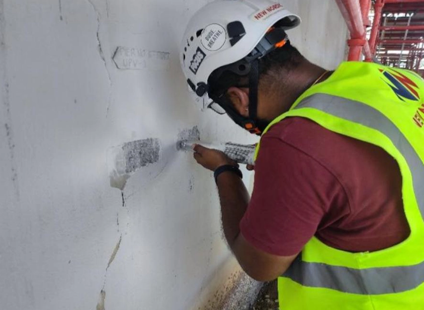 New Nordic engineer carrying out UPV testing at a marked test point on a cracked concrete pier