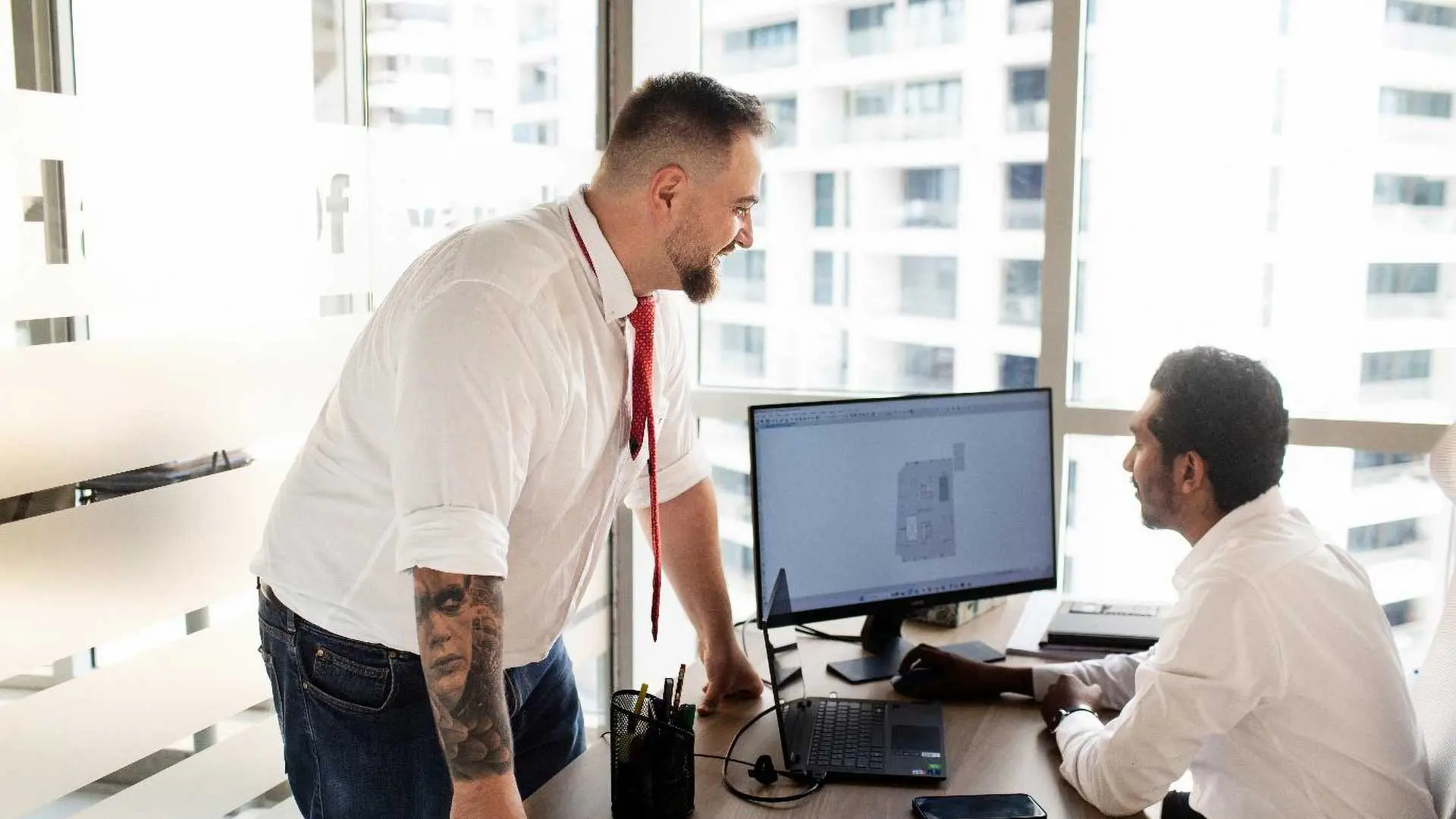 New Nordic engineers reviewing structural drawings on a computer in the office
