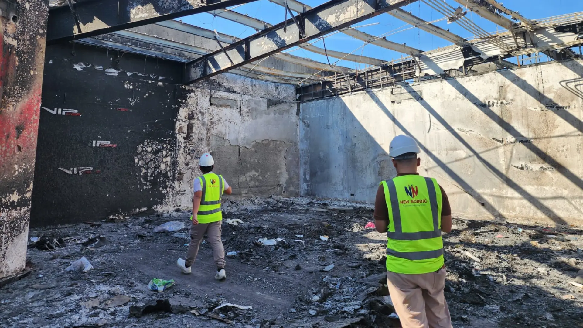 New Nordic engineers assessing a damaged building interior as part of a portfolio programme
