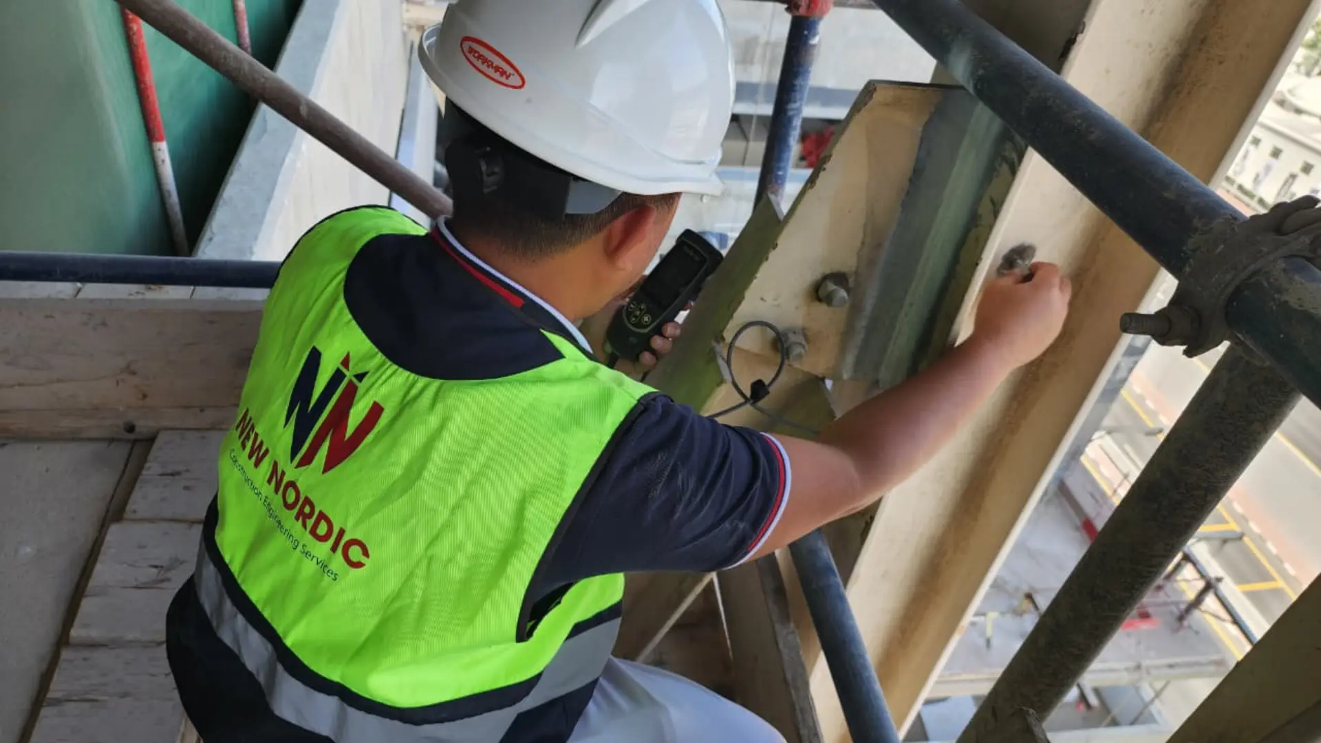 New Nordic engineer performing corrosion testing on structural steel with NDT equipment