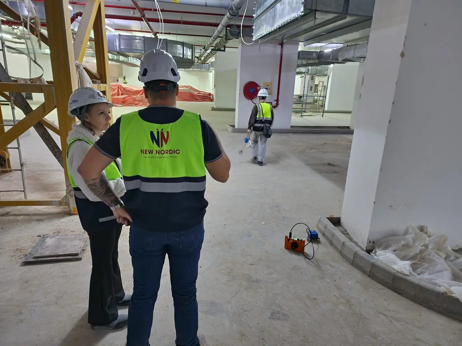 New Nordic team carrying out a survey inside a stripped building interior ahead of structural modification