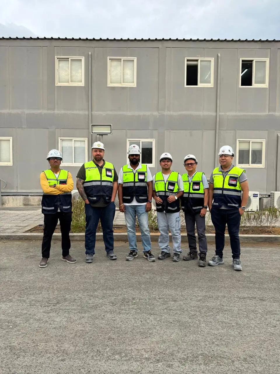 The New Nordic team in hard hats and safety vests outside their office in the UAE