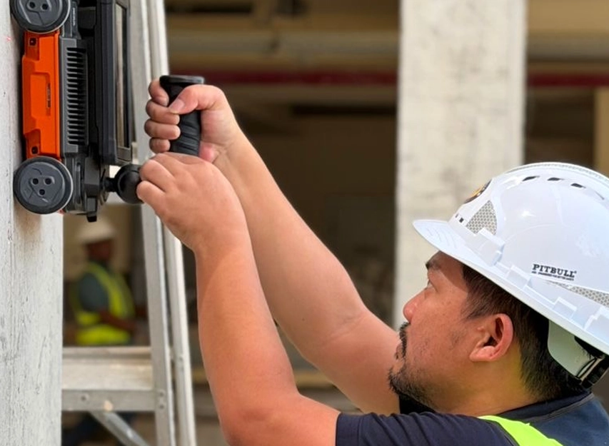 New Nordic engineer testing a concrete wall with a rebound hammer