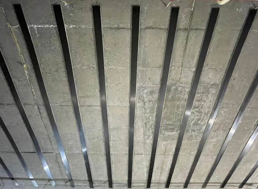 Strengthening strips bonded to a concrete soffit in parallel rows